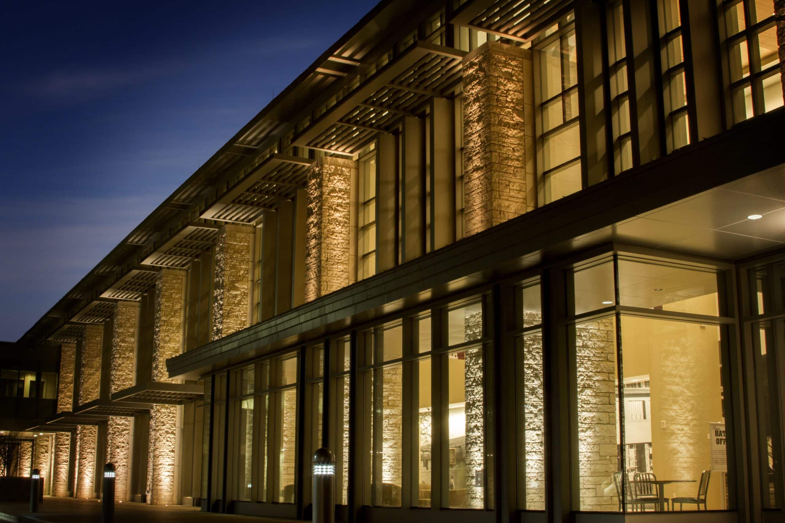 Brightly lit commercial building exterior showcasing energy-efficient lighting design.