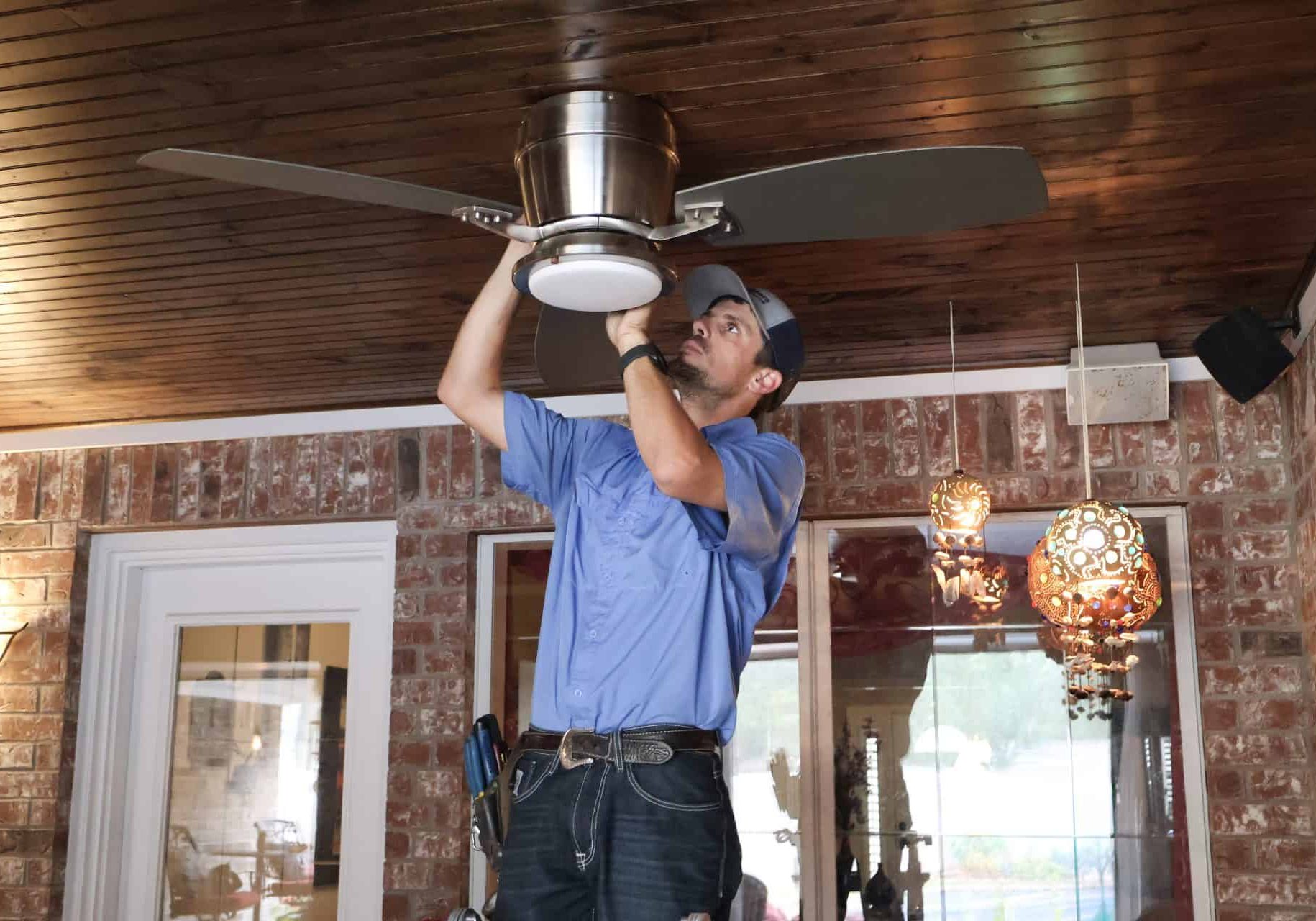 Licensed Britt Rice Electric technician performing a residential ceiling fan installation in a College Station, TX home