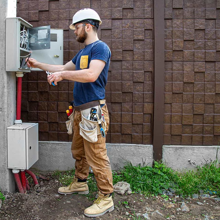 electrician-builder-work-examines-cable-connection-electrical-line-fuselage-industrial-switchboard-professional-overalls-with-electrician-s-tool