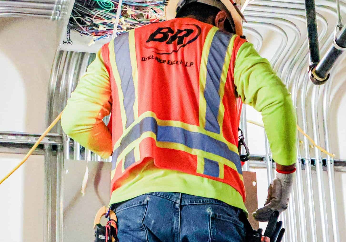 Highly skilled electrician installing wiring and electrical panel for commercial or residential projects.